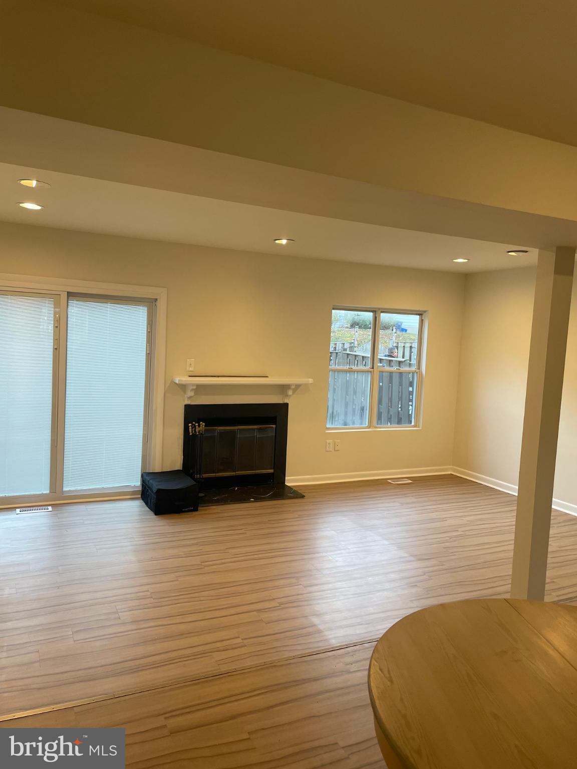 11206 White Barn Court Gaithersburg, MD 20879 - Photo 7 of 21 a view of empty room with wooden floor and fireplace