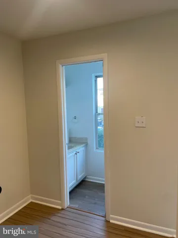 a view of a hallway with wooden floor and windows
