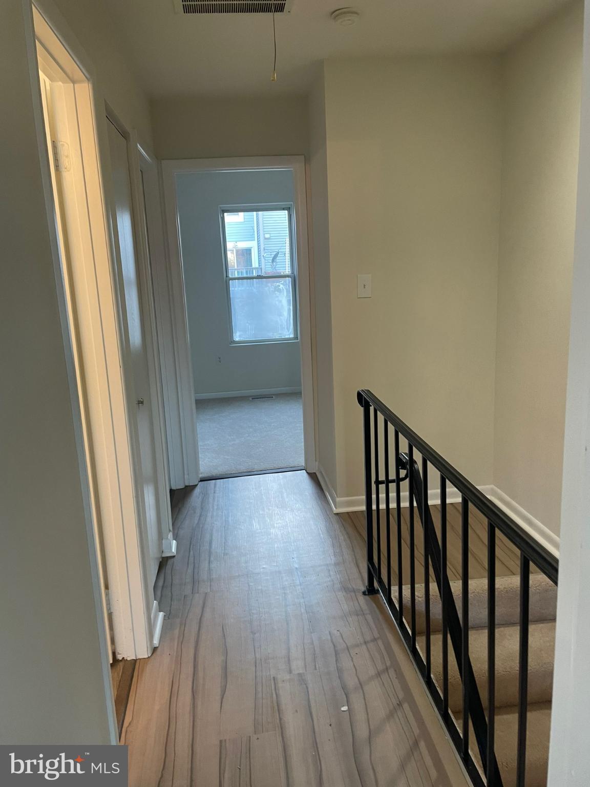11206 White Barn Court Gaithersburg, MD 20879 - Photo 9 of 21 a view of a hallway with wooden floor and windows