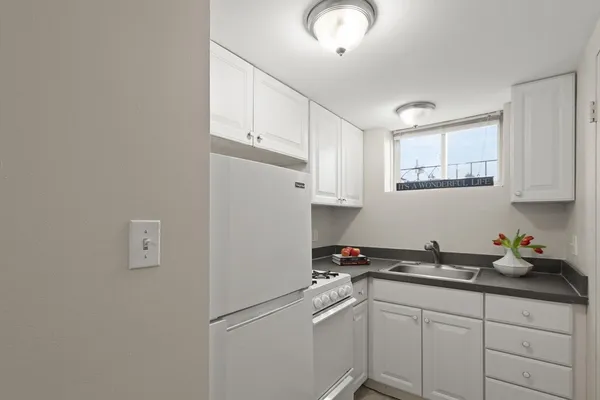 a kitchen with cabinets appliances and a sink