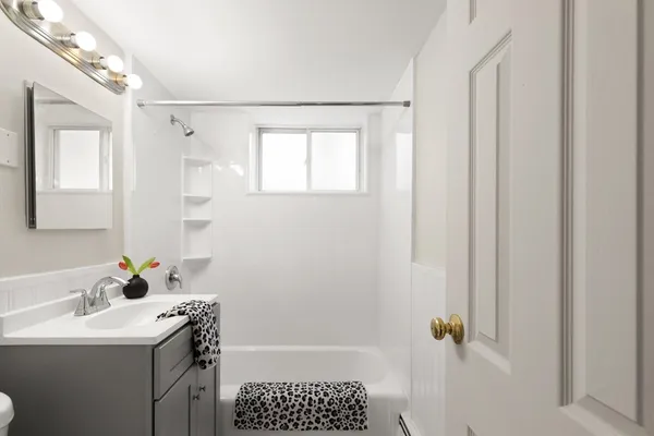 a bathroom with a sink toilet and shower