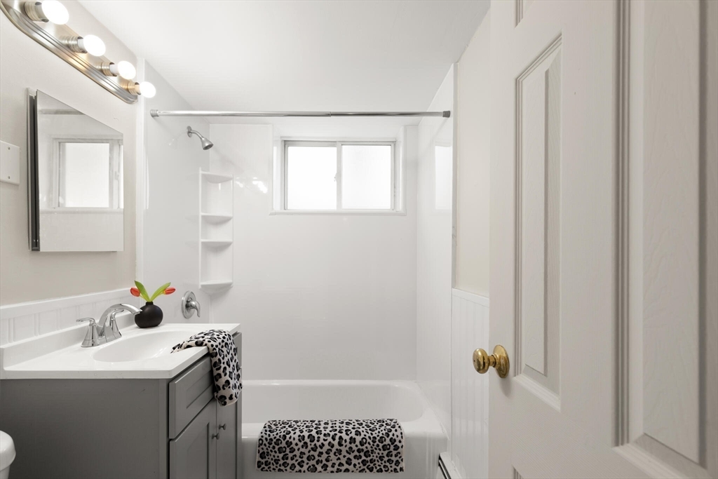 12 Central Avenue, Unit 1 Danvers, MA 01923 - Photo 23 of 25 a bathroom with a sink toilet and shower