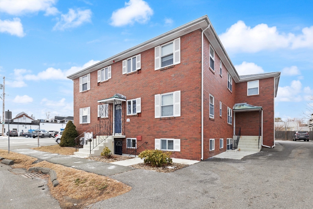 12 Central Avenue, Unit 1 Danvers, MA 01923 - Photo 4 of 25 a front view of a house with a yard