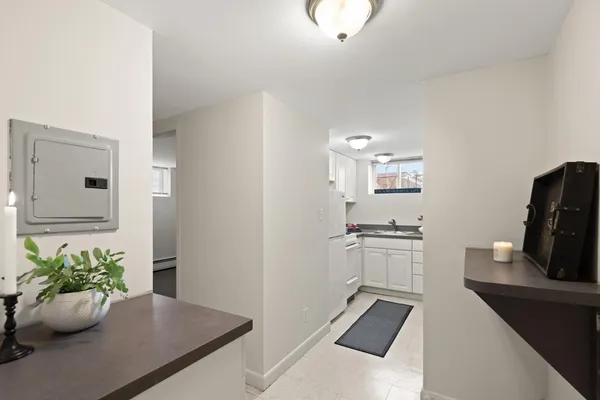 a kitchen with a sink and dishwasher a stove with wooden floor