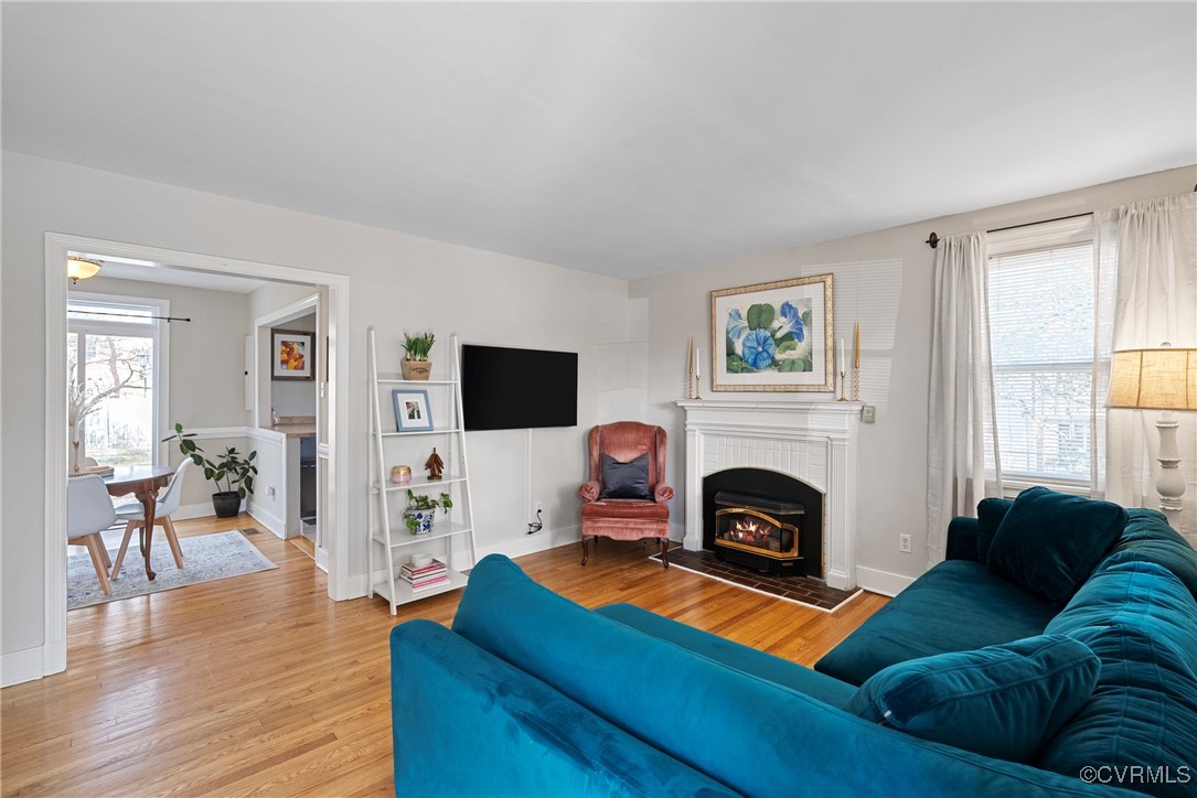 Living room with light wood floors, gas fireplace,
