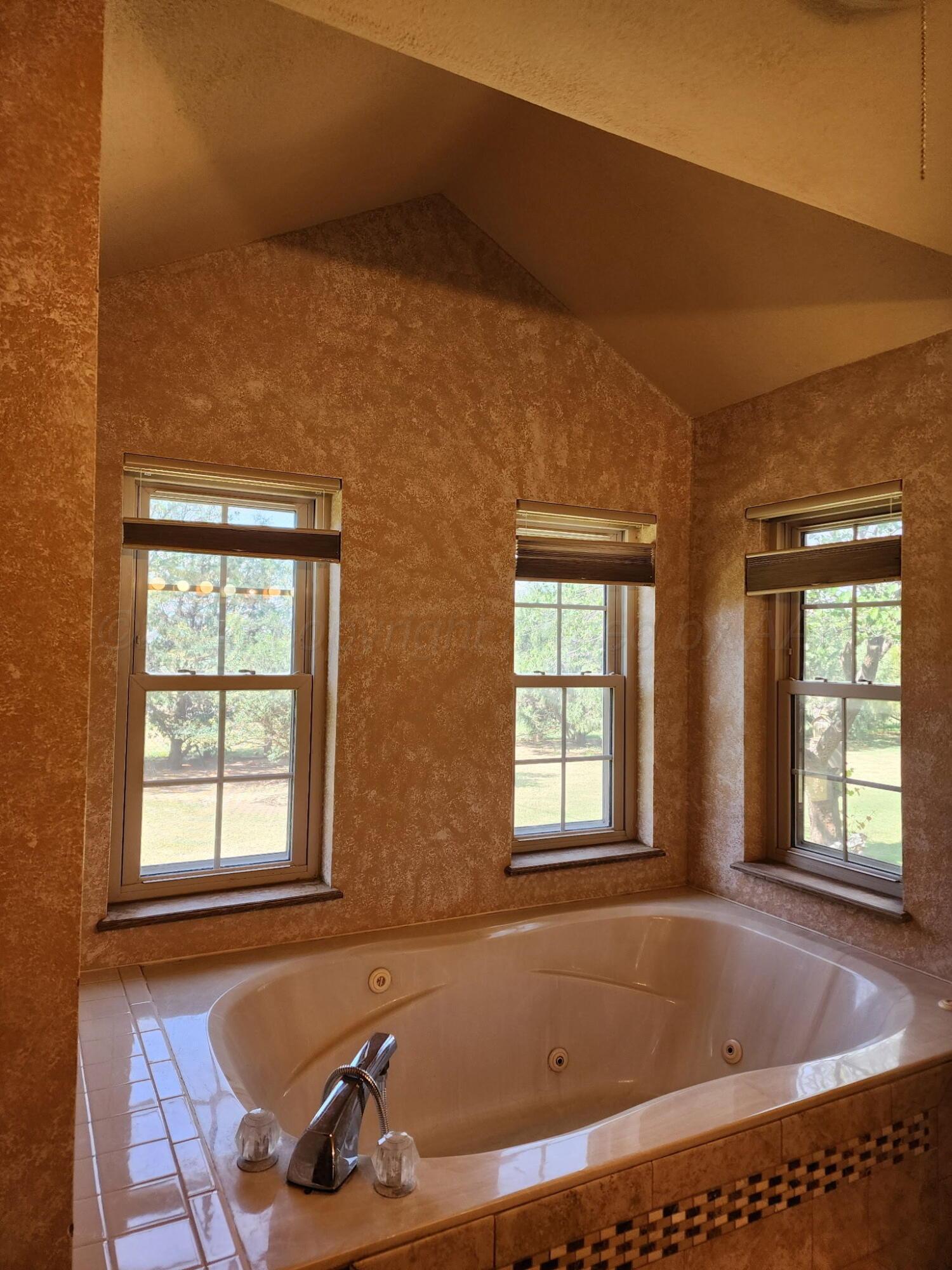 16700 Old Ranch Road Canyon, TX 79015 - Photo 25 of 54 a bath tub sitting in a bathroom next to a window