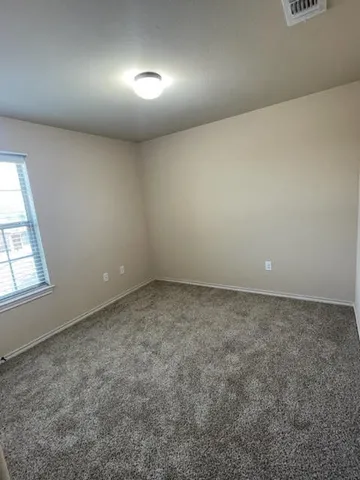 an empty room with a empty space and windows