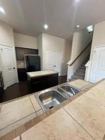 a kitchen with a refrigerator sink and stove