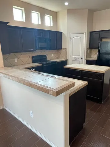 a kitchen with a stove and a refrigerator