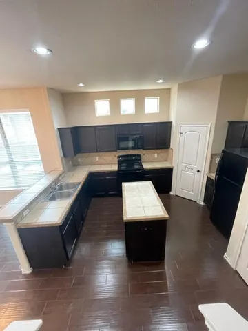 a kitchen with a sink and a refrigerator