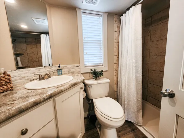 a large bed sitting in a bedroom next to a lamp