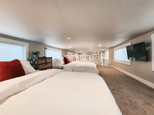 a bedroom with two beds and a night stand