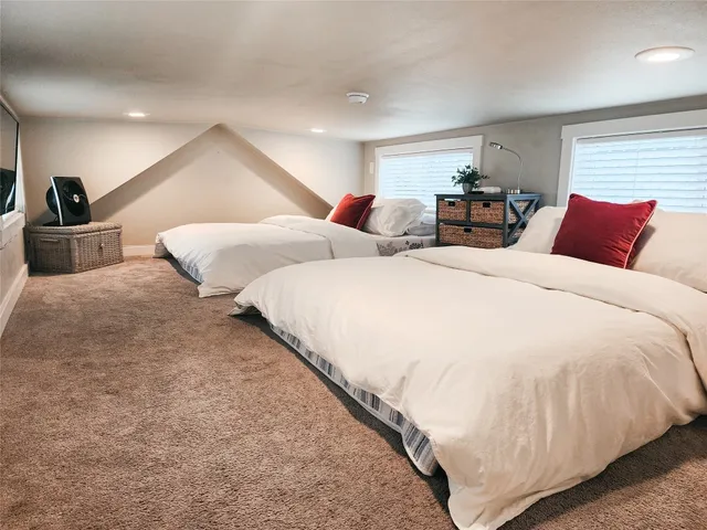 a bathroom with a granite countertop toilet sink and mirror