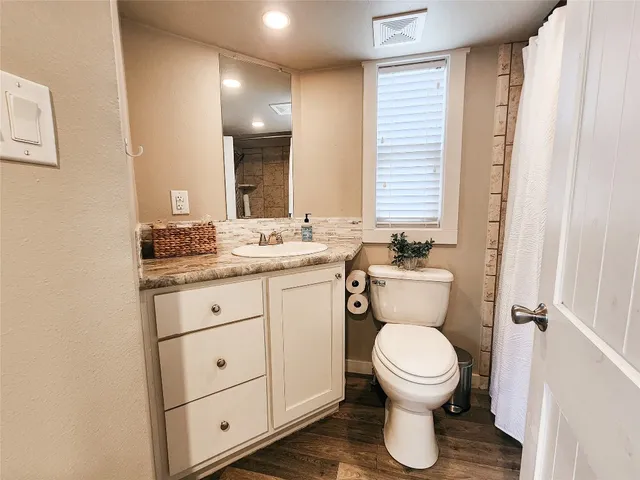 a view of a lake with a yard and trees all around