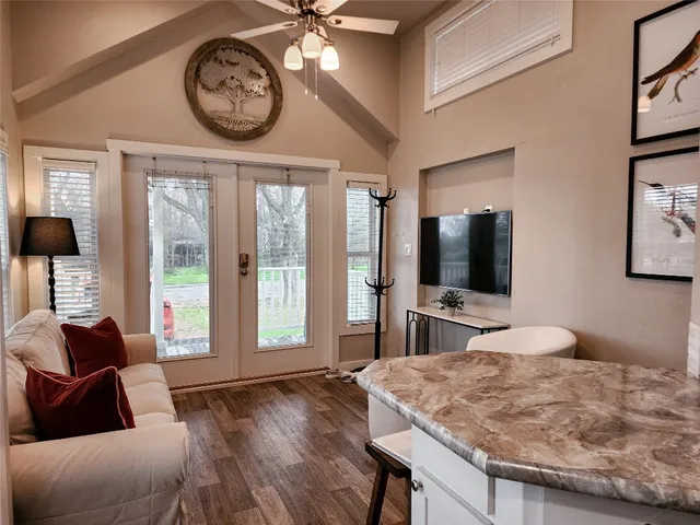 a living room with furniture and a chandelier