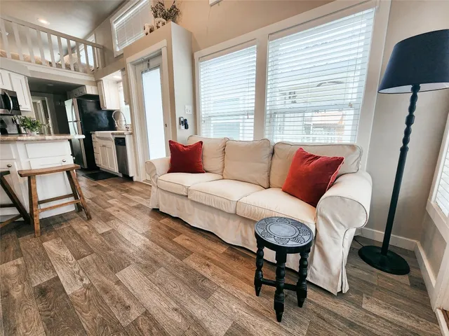 a living room with furniture or wooden floor and a large window