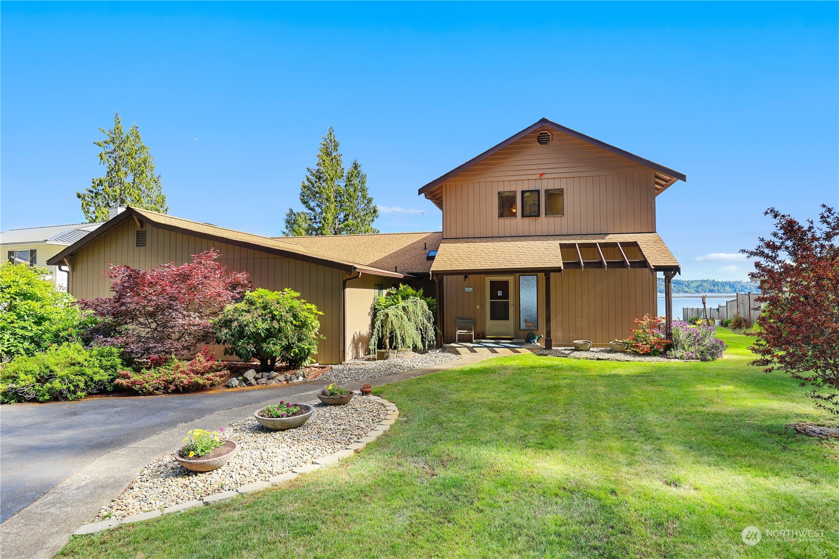 101 Northeast Sundstrom Road Belfair, WA 98528 - Photo 1 of 40 a front view of a house with a yard and garage