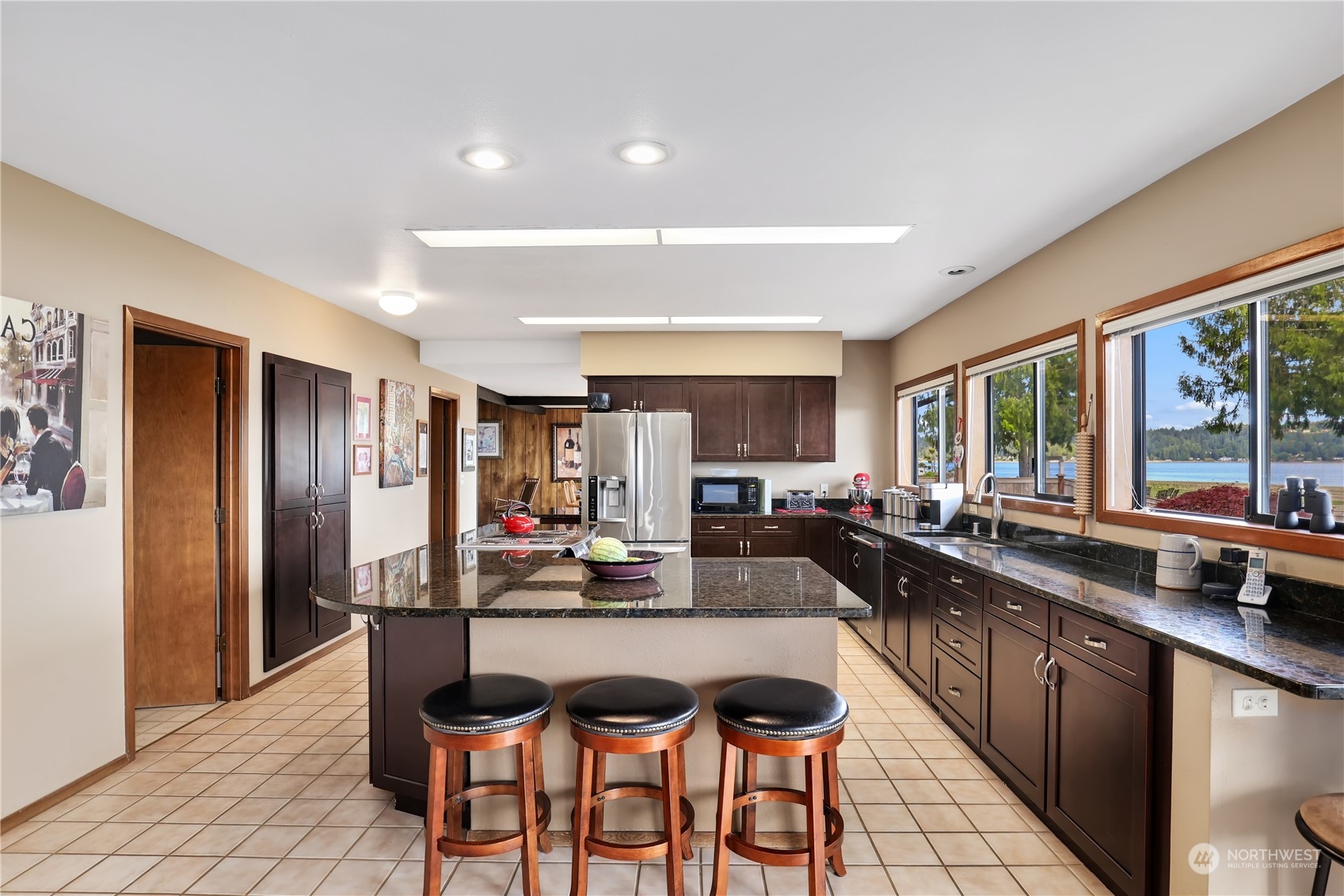 101 Northeast Sundstrom Road Belfair, WA 98528 - Photo 11 of 40 a kitchen with a dining table chairs and refrigerator