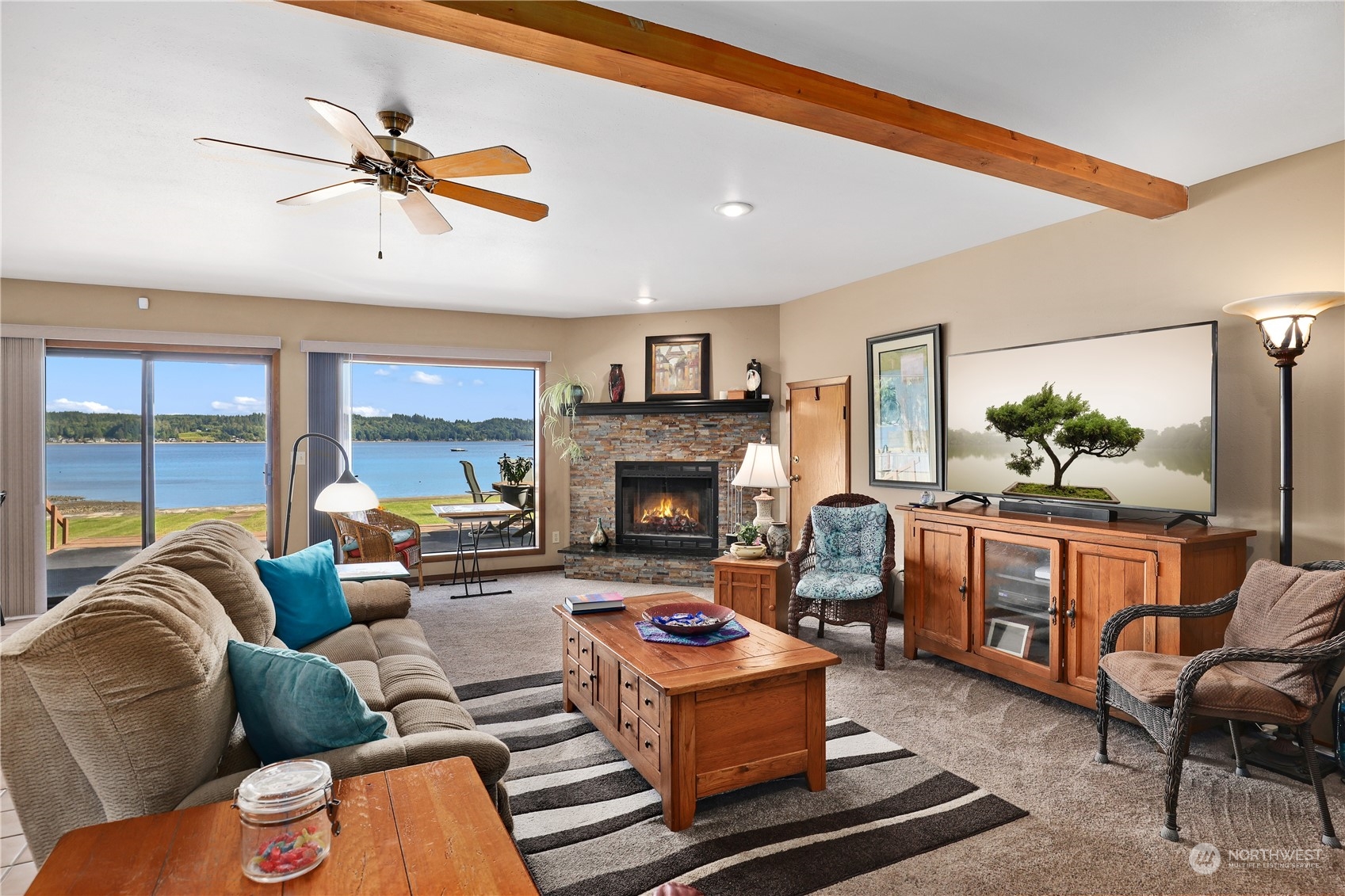 101 Northeast Sundstrom Road Belfair, WA 98528 - Photo 8 of 40 a living room with furniture fireplace and a large window
