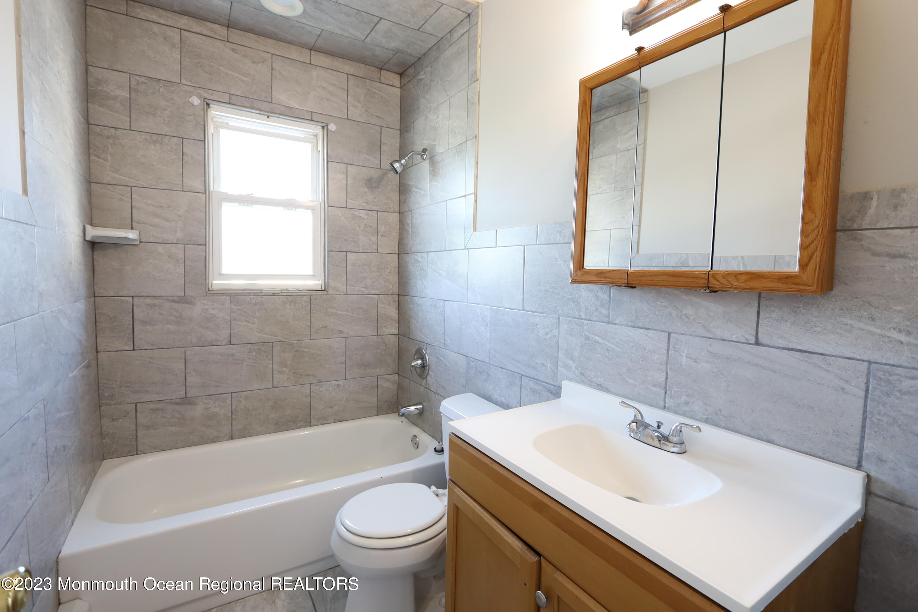 110 Union Avenue, Unit C Lakehurst, NJ 08733 - Photo 5 of 7 a bathroom with a sink a toilet and bathtub