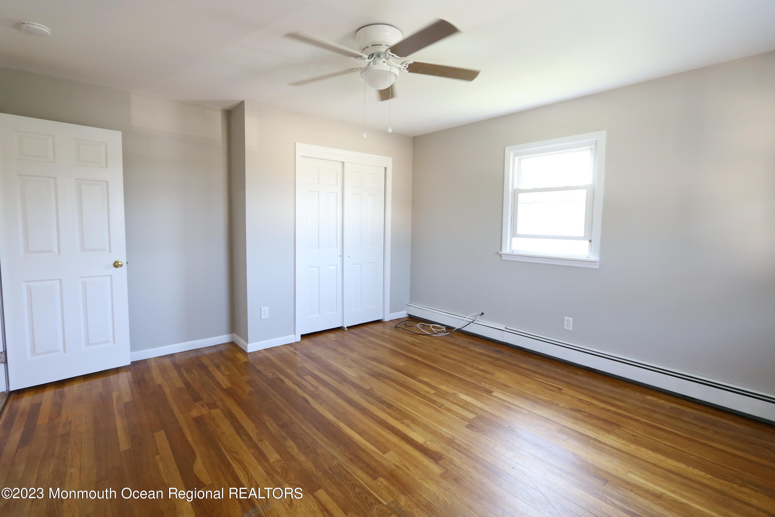 110 Union Avenue, Unit C Lakehurst, NJ 08733 - Photo 7 of 7 a view of an empty room with a window and wooden floor