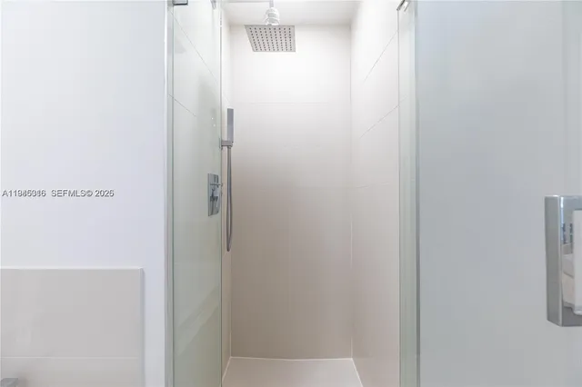 a bathroom with a sink a mirror and a shower