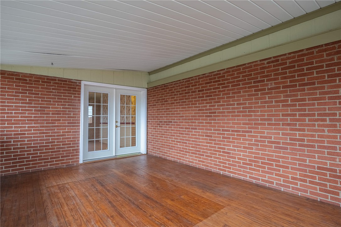 6300 Carnation Road Dayton, OH 45449 - Photo 21 of 35 This inviting porch, featuring rich wood flooring and classic brick, offers a seamless transition to the outdoors.