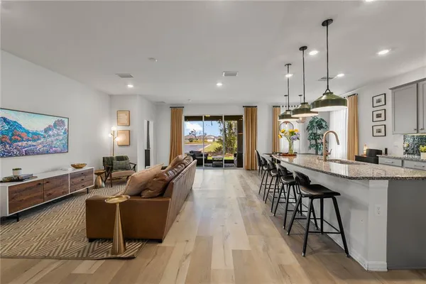a kitchen with a table chairs sink and stainless steel appliances