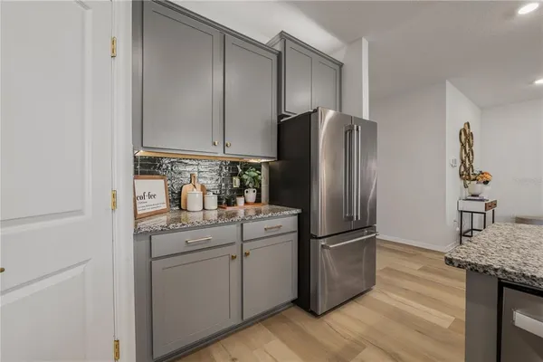 a kitchen with granite countertop a sink a stove and cabinets