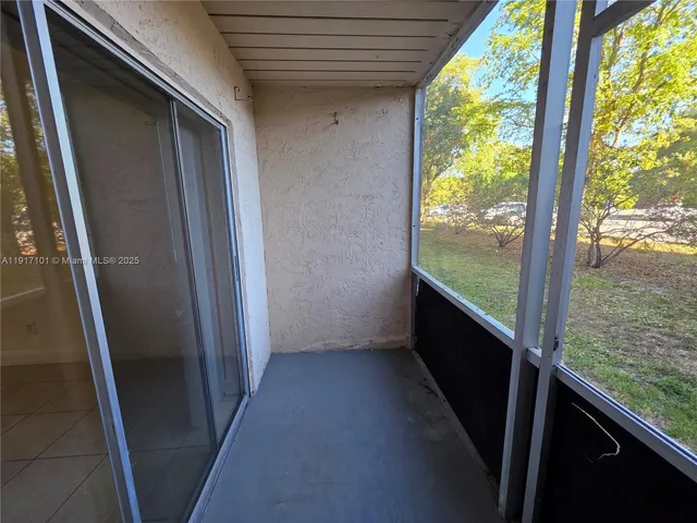 a view of balcony with a yard