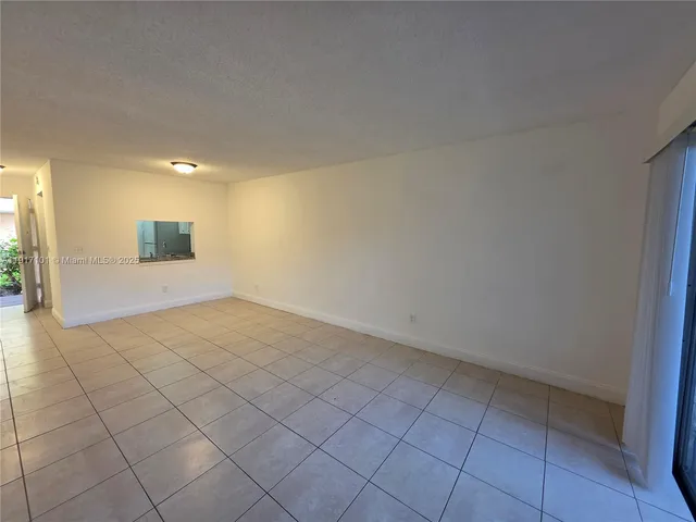 an empty room with a empty space and windows