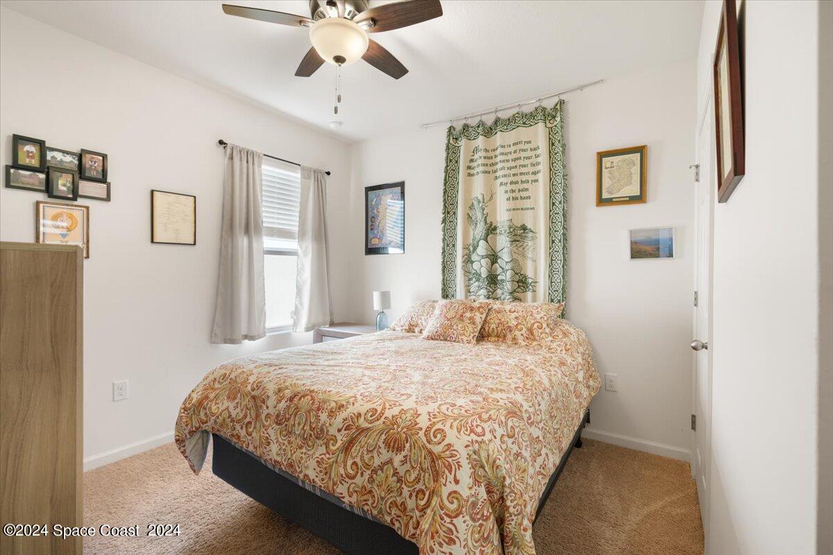 4332 Starling Place Mims, FL 32754 - Photo 19 of 28 a bedroom with a bed and window