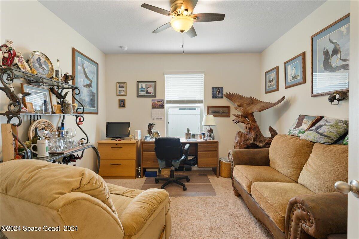 4332 Starling Place Mims, FL 32754 - Photo 21 of 28 a living room with furniture and a flat screen tv