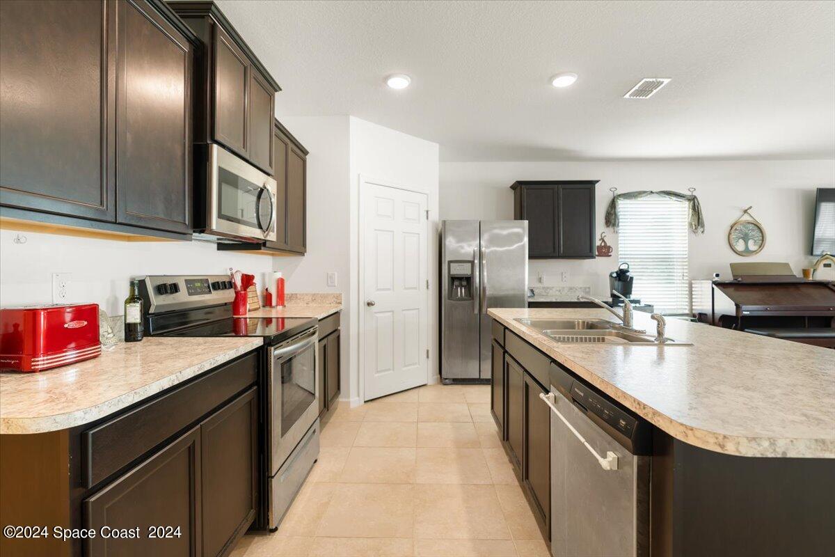 4332 Starling Place Mims, FL 32754 - Photo 5 of 28 a kitchen with a sink stove top oven and cabinets