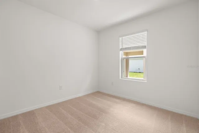 a view of an empty room and a window