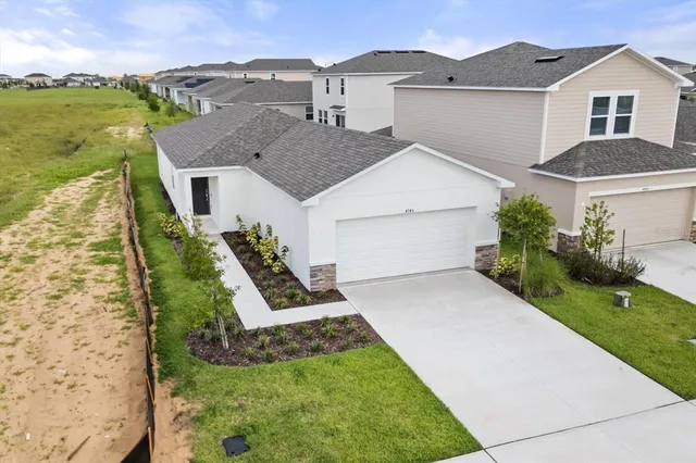 a aerial view of a house next to a yard with potted plants