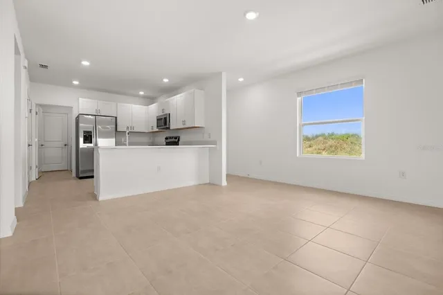 a view of a kitchen with a sink and a refrigerator