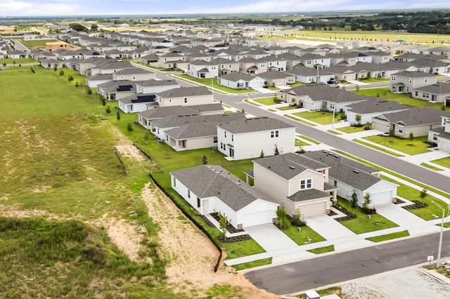 an aerial view of residential houses with outdoor space