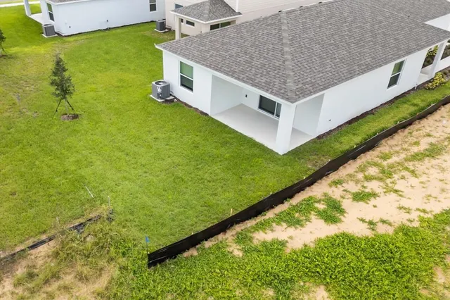 a aerial view of a house with a yard