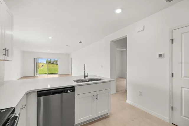 a kitchen with stainless steel appliances granite countertop a sink and a window