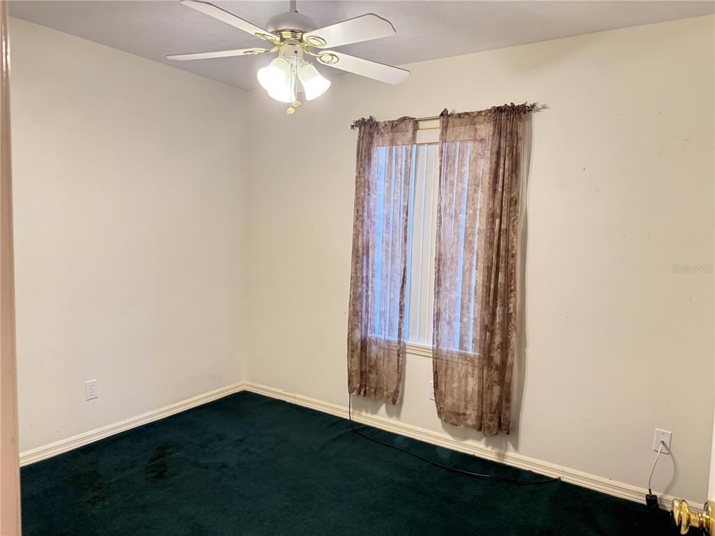 4262 Northeast 35th Avenue Road Ocala, FL 34479 - Photo 12 of 25 a view of a room with wooden floor and fan