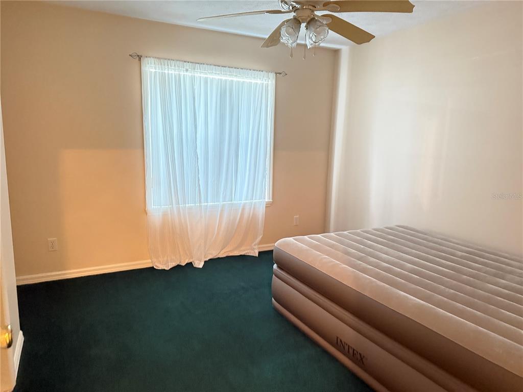 4262 Northeast 35th Avenue Road Ocala, FL 34479 - Photo 15 of 25 a bedroom with a bed and a chandelier