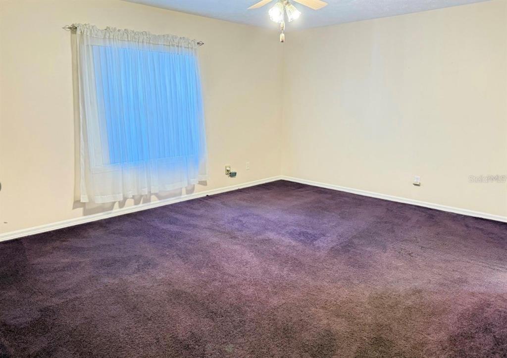 4262 Northeast 35th Avenue Road Ocala, FL 34479 - Photo 20 of 25 an empty room with a chandelier fan