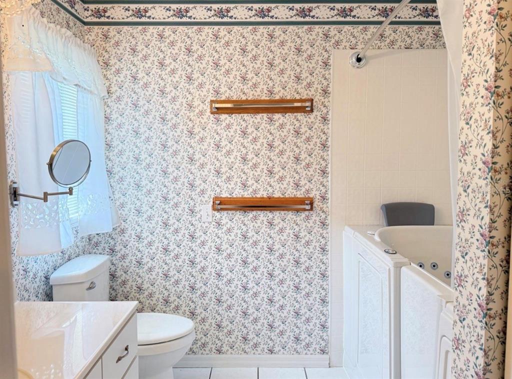 4262 Northeast 35th Avenue Road Ocala, FL 34479 - Photo 21 of 25 a bathroom with a toilet and a shower curtain