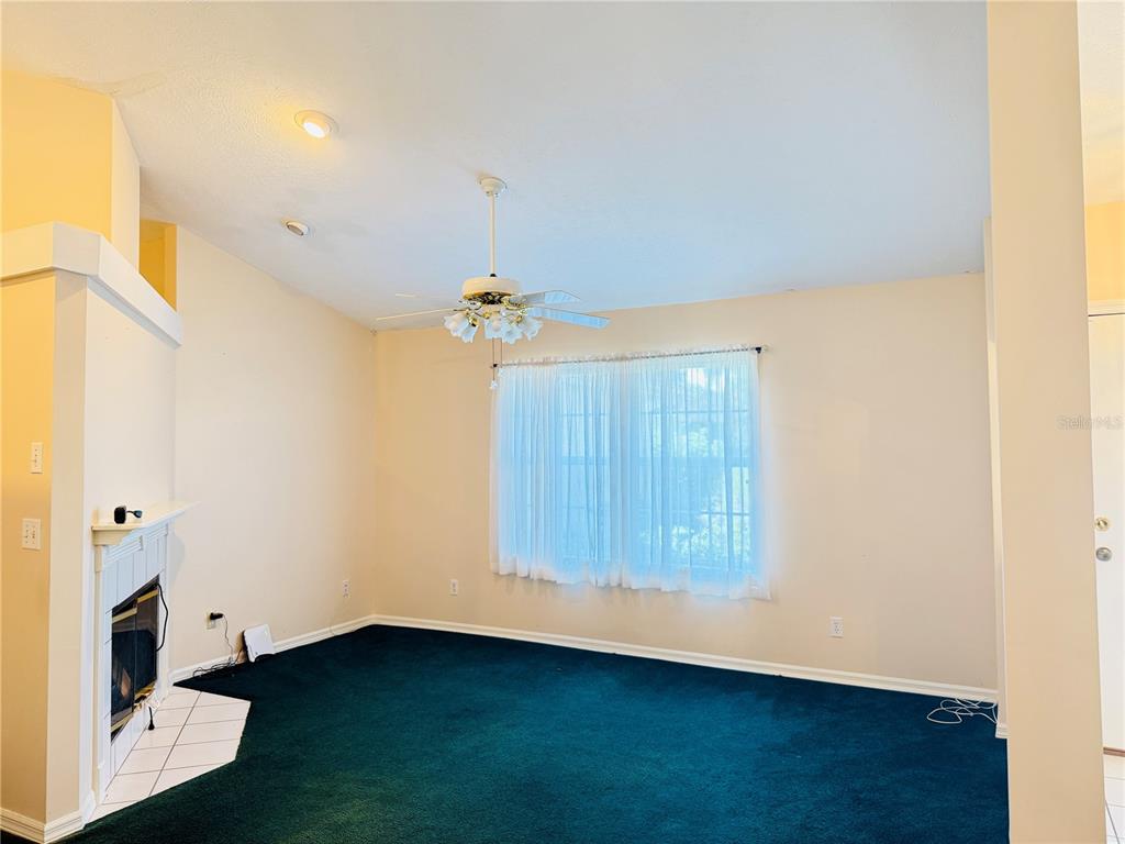 4262 Northeast 35th Avenue Road Ocala, FL 34479 - Photo 6 of 25 a view of an empty room with wooden floor and a window