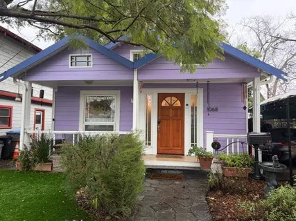 a front view of a house with garden
