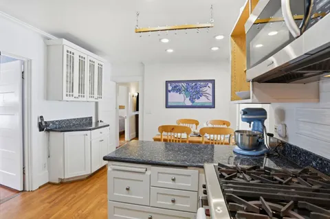 a kitchen with stainless steel appliances granite countertop a stove and a sink