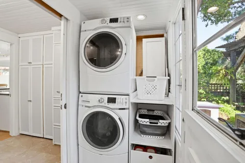 a view of a hallway with washer and dryer