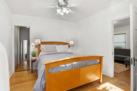 a bedroom with a bed and a chandelier
