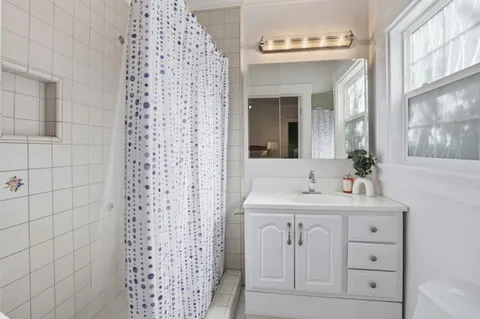 a bathroom with a sink a vanity and a mirror